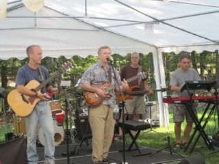 Patrick displays notable virtuosity on the cowbell at a private party in the mountains between Winchester and West Virginia, August, 2012
