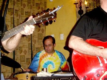 Brothers November 3, 2005. Rob drums away, flanked by the hairy arms of black-shirted guitarists! Good thing he wears that tie-dyed shirt so the camera woman can spot him!
