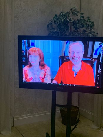 Dr Rabbi Charlie Kluge and his wife on the second  TV screen on set
