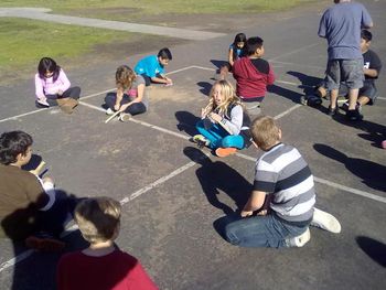 2013 Martin with the kids sanding their bamboo flutes to prepare them for artwork
