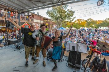 Fun Wurstfest crowd!  Ross and Valina pictured with the late, great drummer, Jeff Ryder at the Stelzenplatz in November 2019.  Photo by Mark Hiebert
