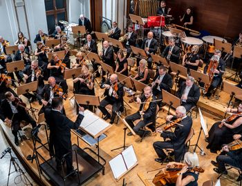 Maestro Slawomir Chrzanowski conducts the Symphony Orchestra of the Zabrze Philharmonic during the performance of a composition by Pawel Pudlo. [photo by Pawel Janicki]
