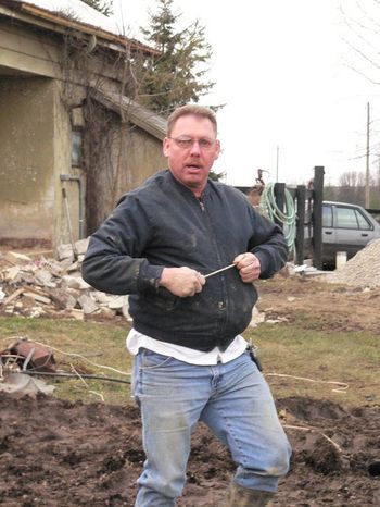 Bob Wallace, looking a little surprised... he just climbed out of the ditch after fixing the busted water line. I think Charlie broke it again 15 minutes later...what a team!!!
