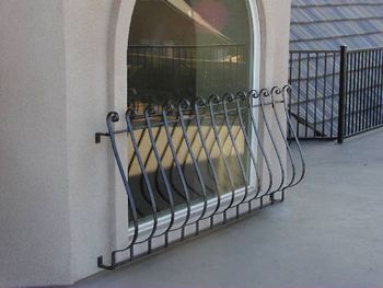 Decorative iron window/porch enhancement.
