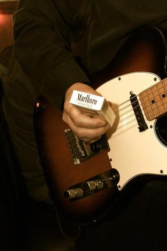 Dave plays guitar with a pack of Marlboro cigarettes at R Bar in Dormont.

