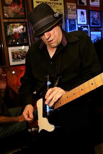 Dave plays guitar with a beer bottle at R Bar in Dormont.
