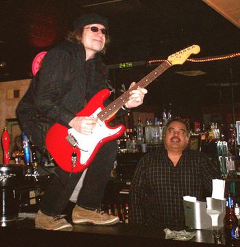 Dave plays guitar on the bar at Casa Tomas.
