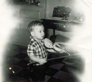 Little David, age 2,toys with a violin. His grandfather, Martin Iglar, was a violinist who encouraged Dave to play music.
