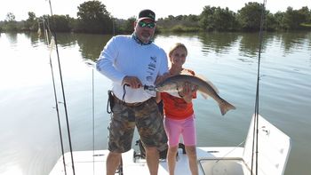 Capt. Mark Brady with Capt. Jesse Wooten's daughter Jessica with a nice redfish caught in Yankeetown.
