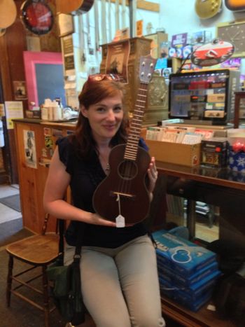 Allison is thinking about learning to play ukelele. Here she is hopelessly falling in love with a $1200.00 Martin mahogany beauty...
