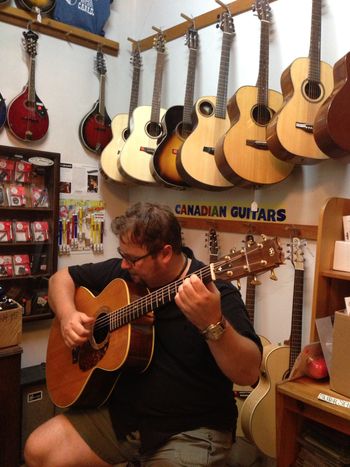 Gerald trying a handmade guitar at the Halifax Folklore Centre, a must-visit for all guitarists...
