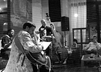 The focus also turned toward live jazz, with two great sets as the the trio romped through standards with some particularly fine solos from all three. Though Chako has only recently arrived in Tokyo, he blended in superbly with now long-time Tokyo stalwarts, Mark Tourian and Cecil Monroe. His guitar was crisp and clean, with a deep reserve of harmonies and soloing ideas.
