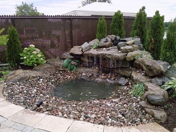 A client was reporting problems with their fountain, we went in and fixed the flow of water, the resevoir tank, the tubing and motor positioning, the pvc liner tarp, added river rocks and two sets of lights- one directional and one under the stream.
