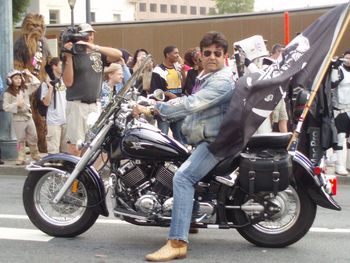 Erik Estrada leads the parade on a motorcycle.... duh.
