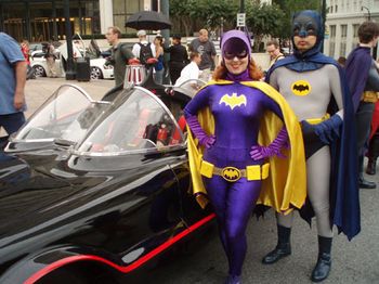 Batman, Batgirl, and the coolest set of wheels.
