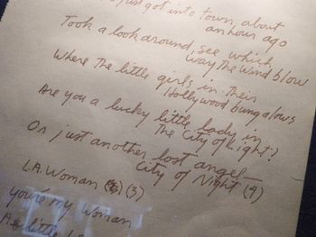 "L.A. Woman" The iconic lyrics to L.A. Woman in Jim Morrison’s own hand. The track L.A. Woman, as well as the entire album by the same title, was recorded here at 8512 Santa Monica Blvd., then The Doors’ Workshop (rehearsal hall/offices). The album was recorded downstairs, with producer Paul Botnick and the mixing board located upstairs. The vocals were sung by Morrison were performed in and recorded from the downstairs bathroom.
