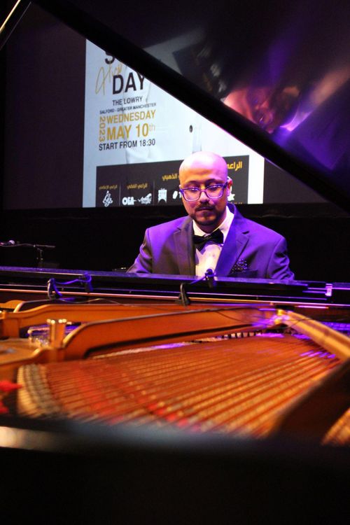 Saber Bamatraf playing piano at the Yemeni Song Day, Manchester