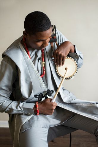 Emmanuel Solomon playing the Nigerian Talking Drum, Gangan