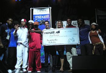 Amy accepting a $20K check from Executive Director Brian Rothschild, Peter Brinkman VP Maxell Corporation and the Black Eyed Peas on July 17 2003
