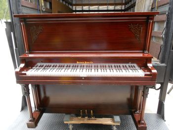 Same 1918 Harvard, Had what we call a stain overwash after a light sanding, This is an alternative to total refinishing if you can't afford that, then a few mist coats of Shellac. If you have a small budget as in 5 - 600 dollars this is how we do it. Included was a bench, new key covers,Decal, Delivery and final tuning after delivery.
