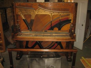 Front view that I added to show off the pristine soundboard. This piano is massive in size, now the dolly does make it look taller but off the dolly it's still 65 inches tall. Gutted and stripped out it still weighs over 600 lbs. Walnut is heavy!
