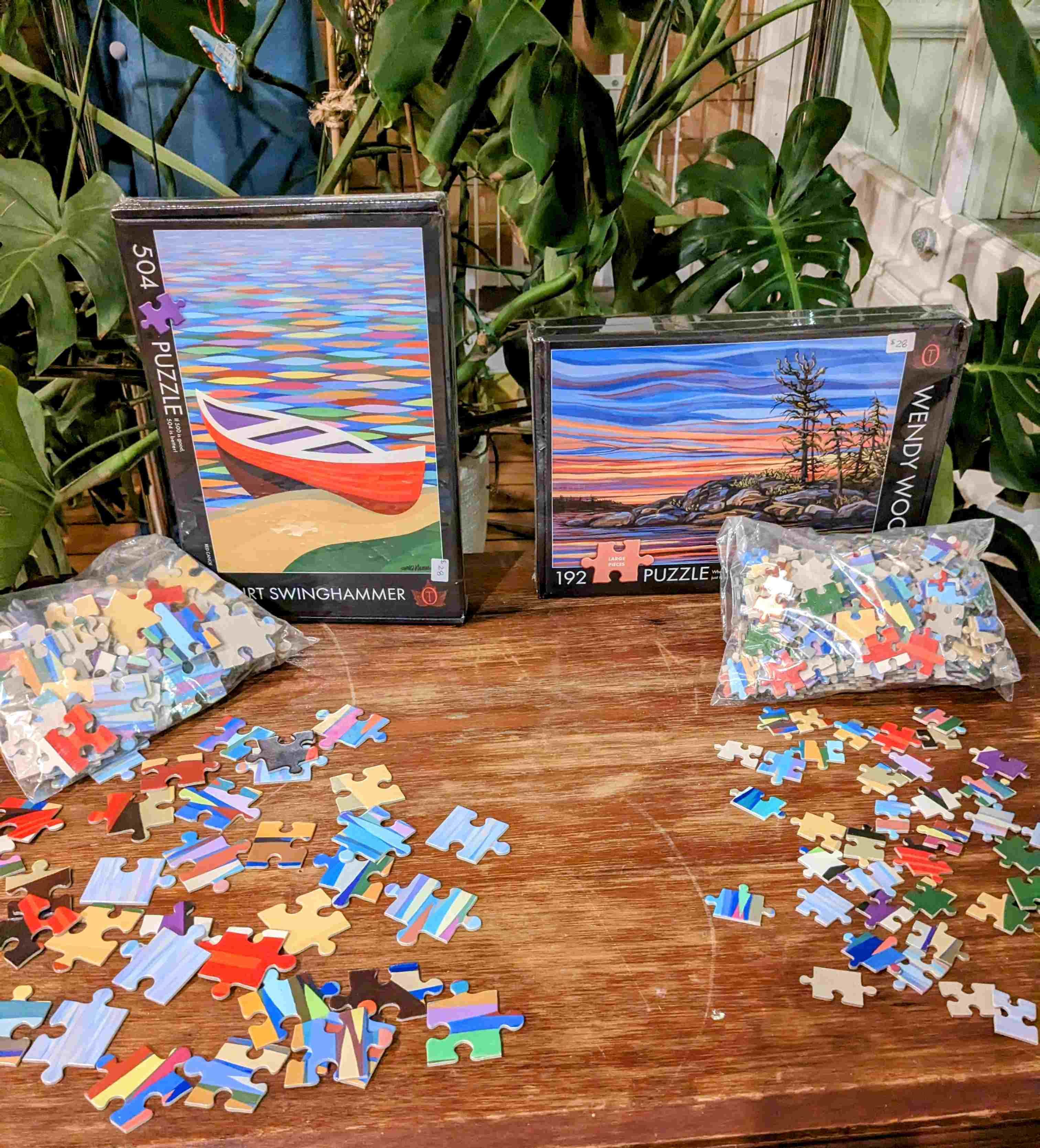 Two puzzles by TheOccurence on a table with plants in the background