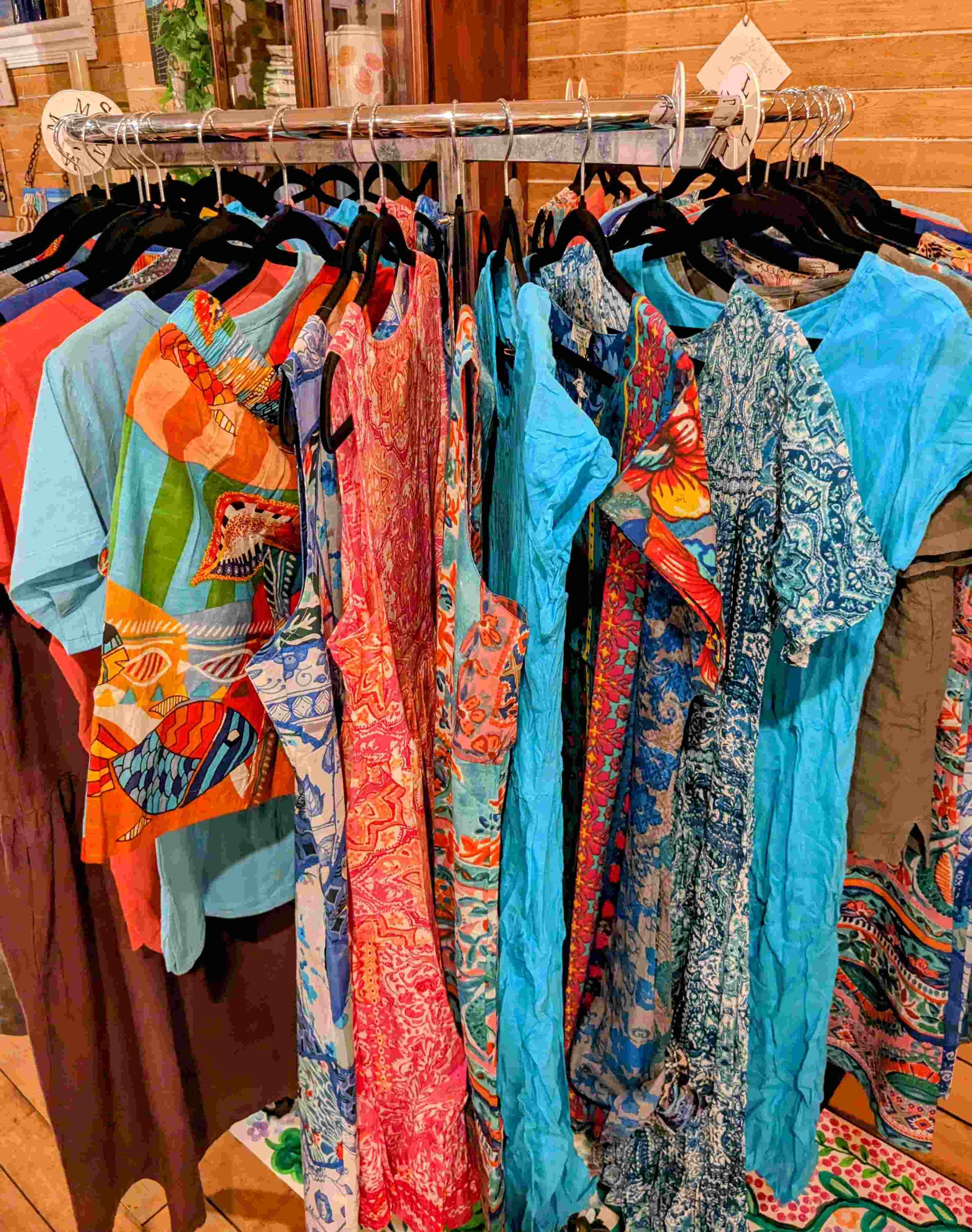 A rack of colourful women's clothing by Orientique