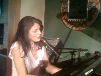 Marta singing at the piano
