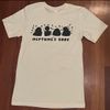 T-shirt:  Off-white shirt with navy blue design