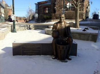 Who's this guy in Bronze sitting on in front of Baker Bob's ?
