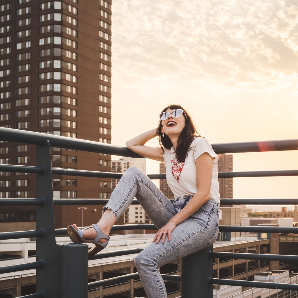 Leslie Vincent smiling on a balcony overlooking Minneapolis.