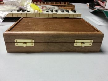 Maple case with walnut stain.
