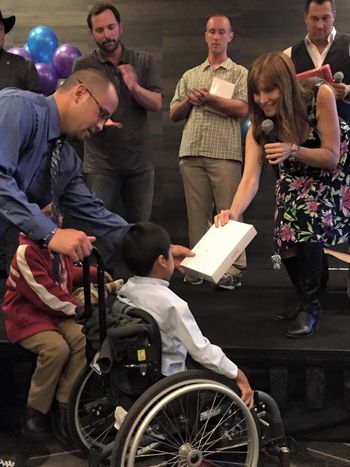 Sandi Shaner, Greg Reid, Frank Shankwitz, Clint August, Jordan Zuniga, and Erik Swanson hand out iPads to Carly's Cause kids.
