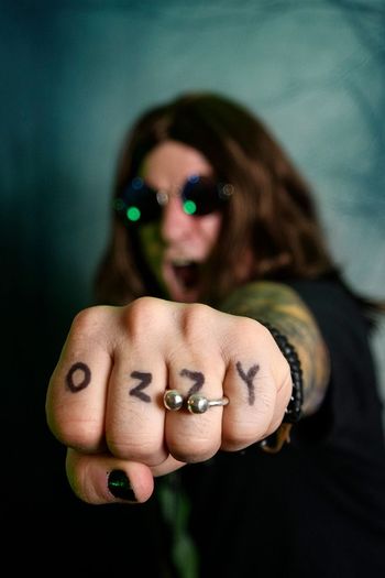 English rock singer Ozzy Osbourne shows off the letters of his name,...  News Photo - Getty Images