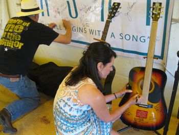 Signing the award guitar for Jackson Gulick, whose song won the male songwriter division
