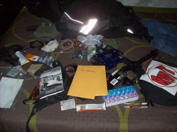 The contents of my tour pack strewn across the bed
