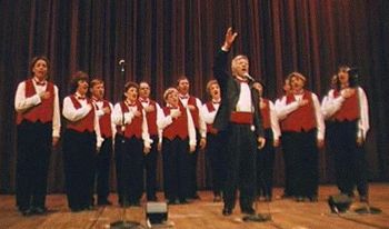 Chuck Petersen turns to the audience and directs them as well as we sing The Star Spangled Banner.
