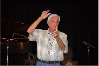 Glenn Wilson, a fellow long, tall Texan conducting the group in a song.
