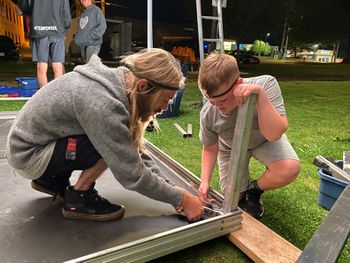 With Trevor Linde, building the stage at Charles Hoey Park for The 39 Days of July 2021
