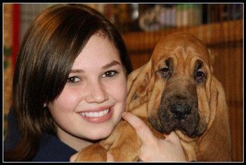 This is Heather Hall. She showed Elsa and now is working with and showing her puppies Madi & Oliver. In their first weekend out together Madi & Heather took 6 points with a huge major win at the Cleveland Classic show. Heather's family are animal lovers and it really shows! Here Heather is holding a darling Bloodhound pup. Thanks so much Heather!
