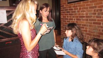 Signing autographs for my fans at my CD party.
