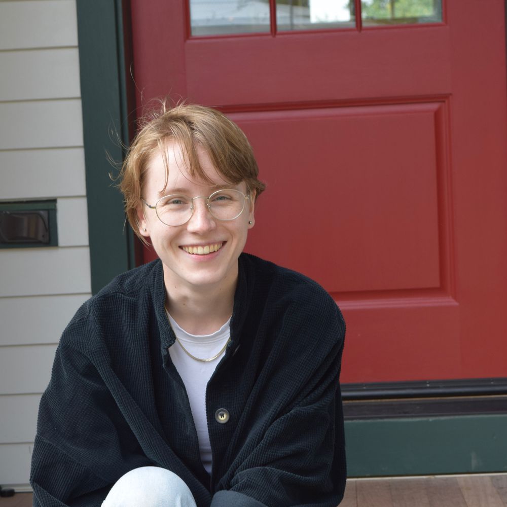 Katherine Paterson smiling in front of a red door