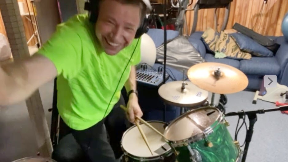 Jason Didner has a good laugh after a mistake recording drums on his multitrack music projects. 