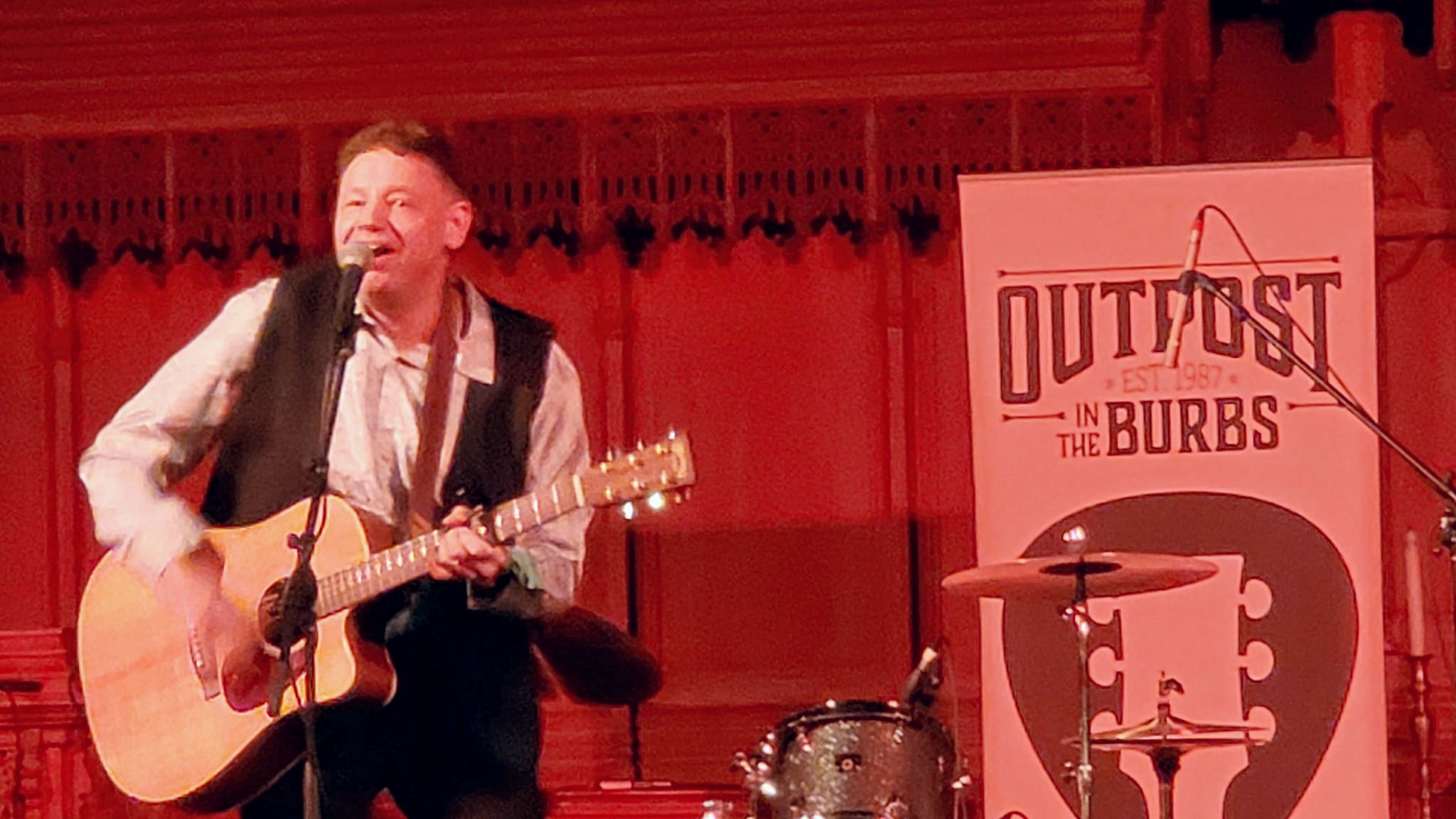 Jason Didner singing and playing acoustic guitar solo at Outpost in the Burbs in Montclair, NJ March 10, 2023. Photo by Nicole Gray