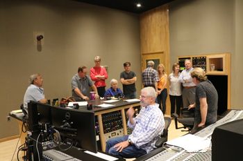 Engineer Bob Clark listening to playbacks, while Bill Pursell (sitting) listens, surrounded by family and friends at The Tracking Room, Nashville.
