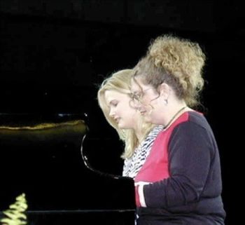 Tracey and Denice Hopper playing a duet at the Pianorama at the National Quartet Convention
