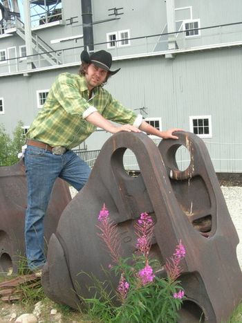 With a bucket from a dredge, Yukon, Canada
