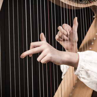 Hands playing a Celtic harp