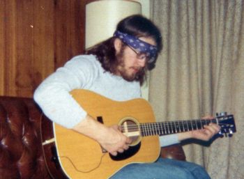 At my 1975 apartment in St.Louis Park. Definitely a "hippie", long hair, headband... my guitar!
