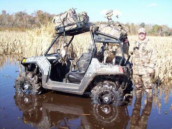 Chris Adams of White House Kennels and "Dixie" reload gear onto our Polaris RZR on one of our duck hunts at Lake Mattamuskeet.
